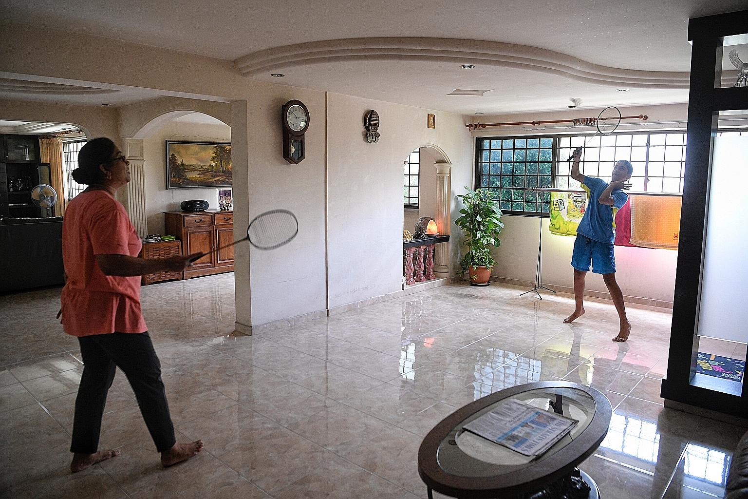 A family playin badminton in their jumbo flat