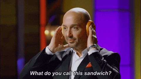 Joe Bastianich holding 2 buns to his ears and asking 'what do you call this sandwich?';